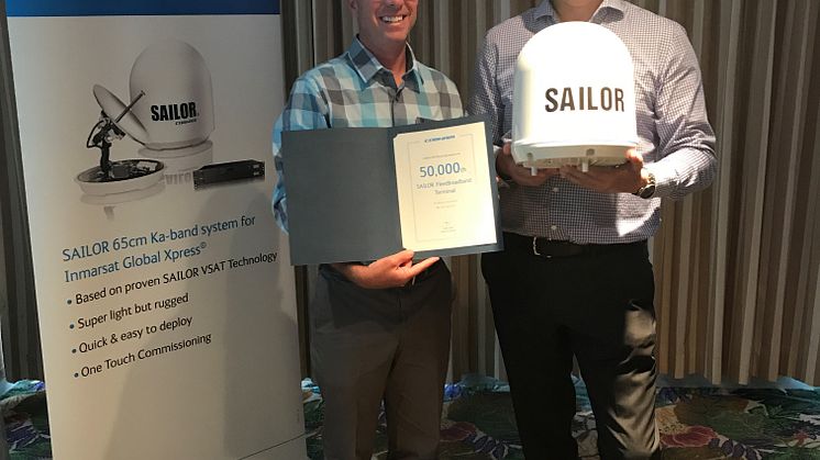 Cobham SATCOM's Henrik Fyhn presents the 50,000th SAILOR FleetBroadband terminal to Matt George (left) of Network Innovations