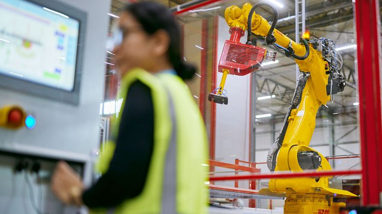 Employee working on a machine (photo DHL).jpeg