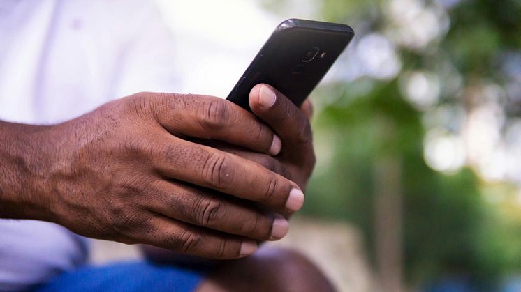 Stock image -Konnect_ person on mobile phone.JPG