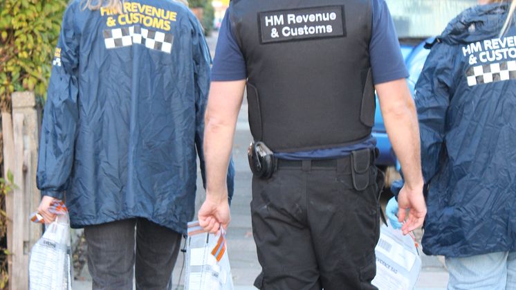 HMRC officers with seized evidence, following a coordinated operation across England into large-scale tax repayment fraud