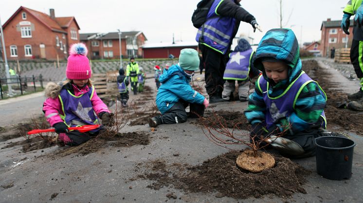 Plantering vid Furulund station - förskolebarn planterar