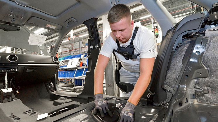 An Audi employee wears the exoskeleton to relieve the back muscles when installing the interior trim during A4 and A5 assembly at the Ingolstadt plant