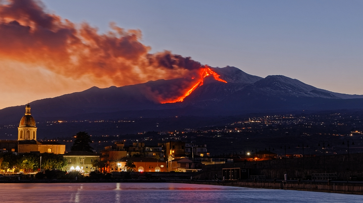 Illuminated buildings in Riposto, Italy, during Etna eruption. Credit: EyeEm Mobile GmbH/Getty Images.