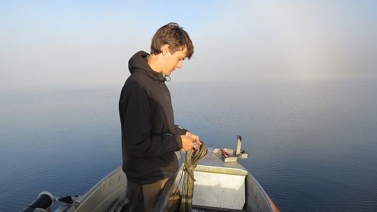 PhD student Fredrik Olajos taking samples in the lake Lotaten, Jämtland, Sweden.