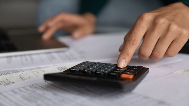 53432154-close-up-young-woman-using-calculator-managing-budget.jpg