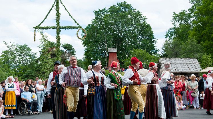 Dancers wearing Swedish traditional costume celebrate Midsummer and the bounties sun and water bring to the planet