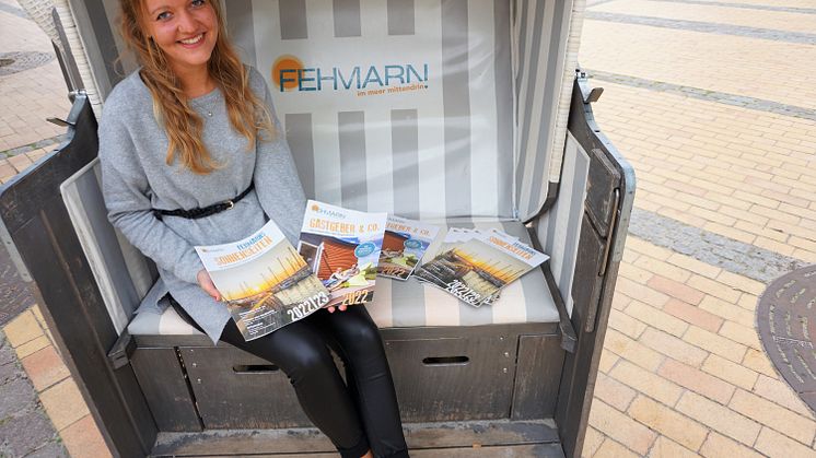 Marketingmitarbeiterin Lina Rotte stellt die neue Urlaubsbroschüre und das Gastgeberverzeichnis für die kommende Saison vor ©Tourismus-Service Fehmarn
