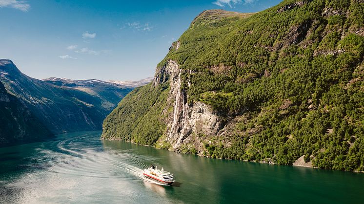 A Hurtigruten ship traveling through Geirangerfjord in Norway. Photo: Agurtxane Concellon
