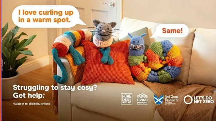 Image shows a beige sofa with a colourful knitted snail and mouse with Home Energy Scotland branding and partner logos