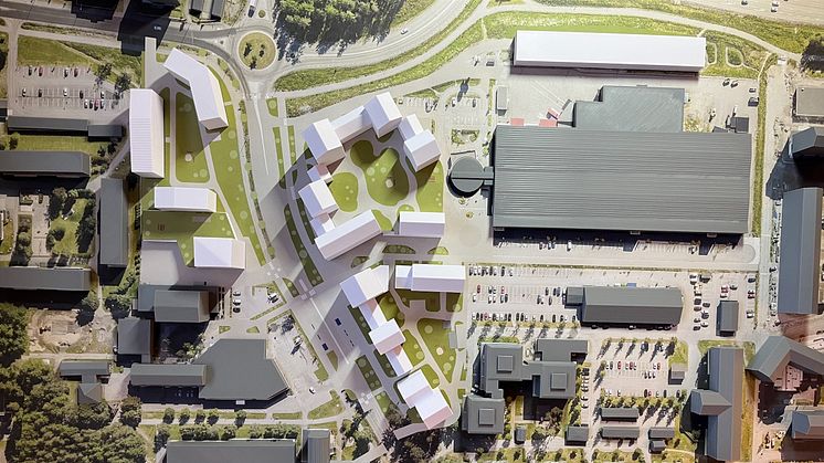 Modell över förslaget till ny detaljplan för Mariehems centrum. Bilden visar hur området kan utvecklas med nya bostäder, torg, tryggare gång- och cykelvägar samt nya parkeringslösningar. De vita byggnaderna markerar tillkommande bebyggelse.