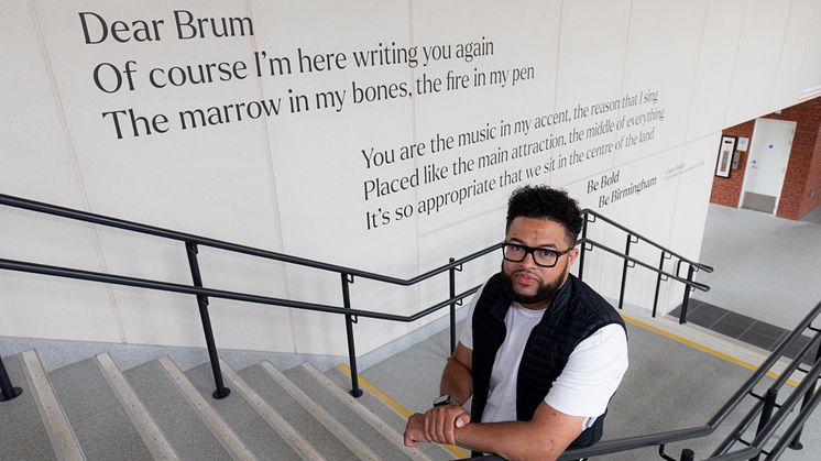 Casey Bailey with the "Dear Brum" art installation at University station in Birmingham