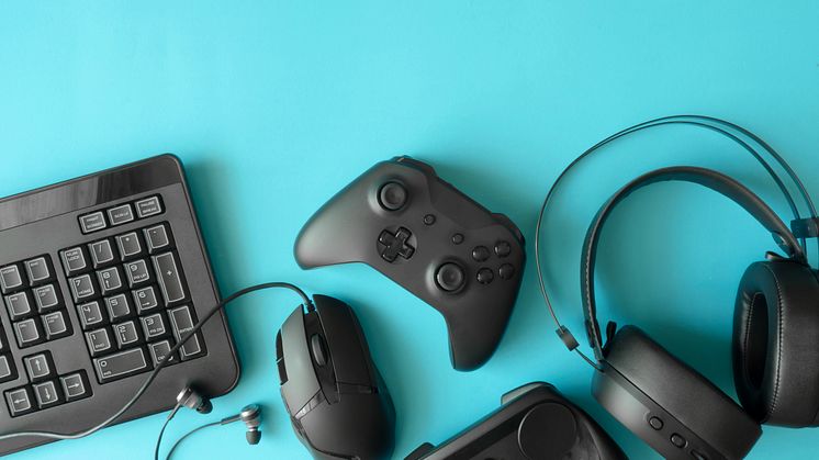 Photo of games console, keyboard, mouse and headphones
