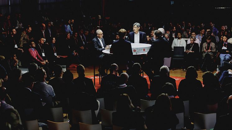 The image shows a debate taking place during the Falling Walls Science Summit.
