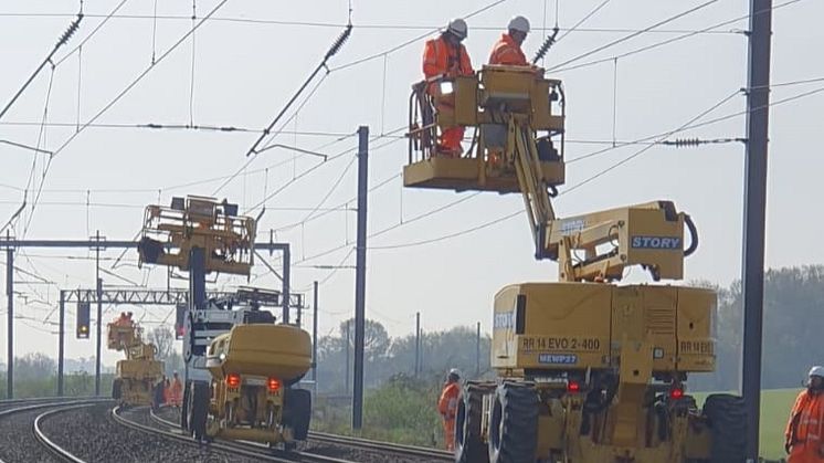 Engineers working on the overhead line
