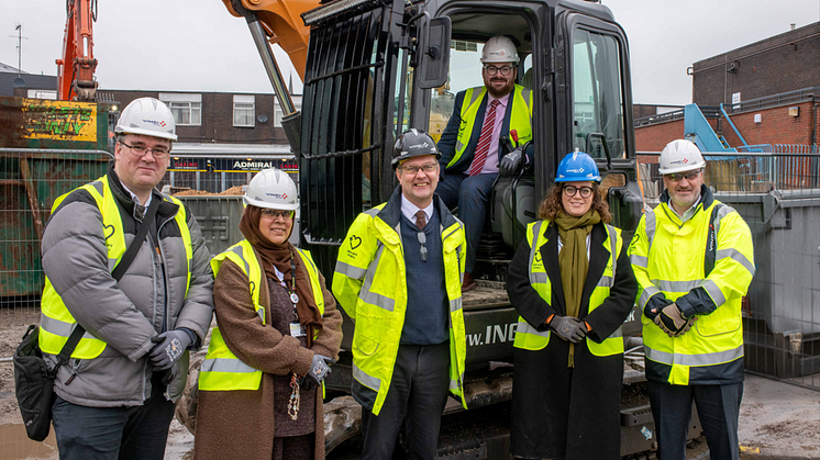 At the groundbreaking event are (in digger) Cllr Eamonn O'Brien, with (front, from left) Cllr Gavin McGill; Cllr Ummrana Farooq; Nick Parkinson, project manager at VINCI; Cllr Charlotte Morris; and David George from H Architects.