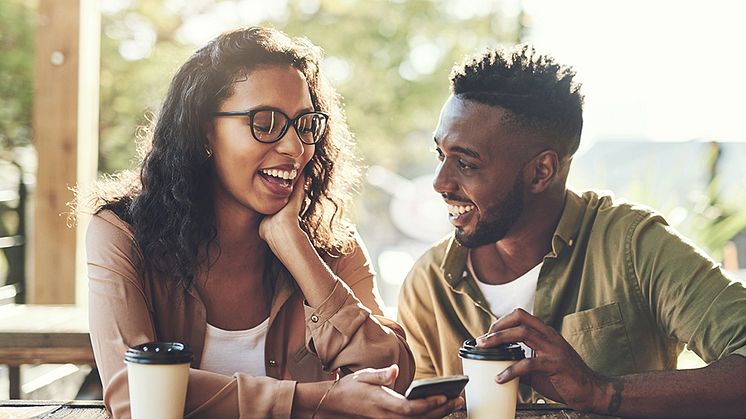 mp65118948-couple-laugh-or-social-media-with-smartphone-in-cafe MND.jpg
