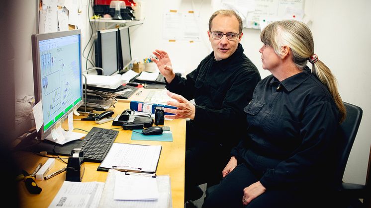 Lantbruksforskare diskuterar framför datorskärm.