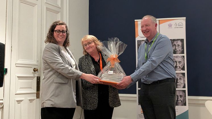 Bernie Garner, director of community services at The Fed, presents the books to Cllr Charlotte Morris and David Fielding, deputy head of libraries and archives.