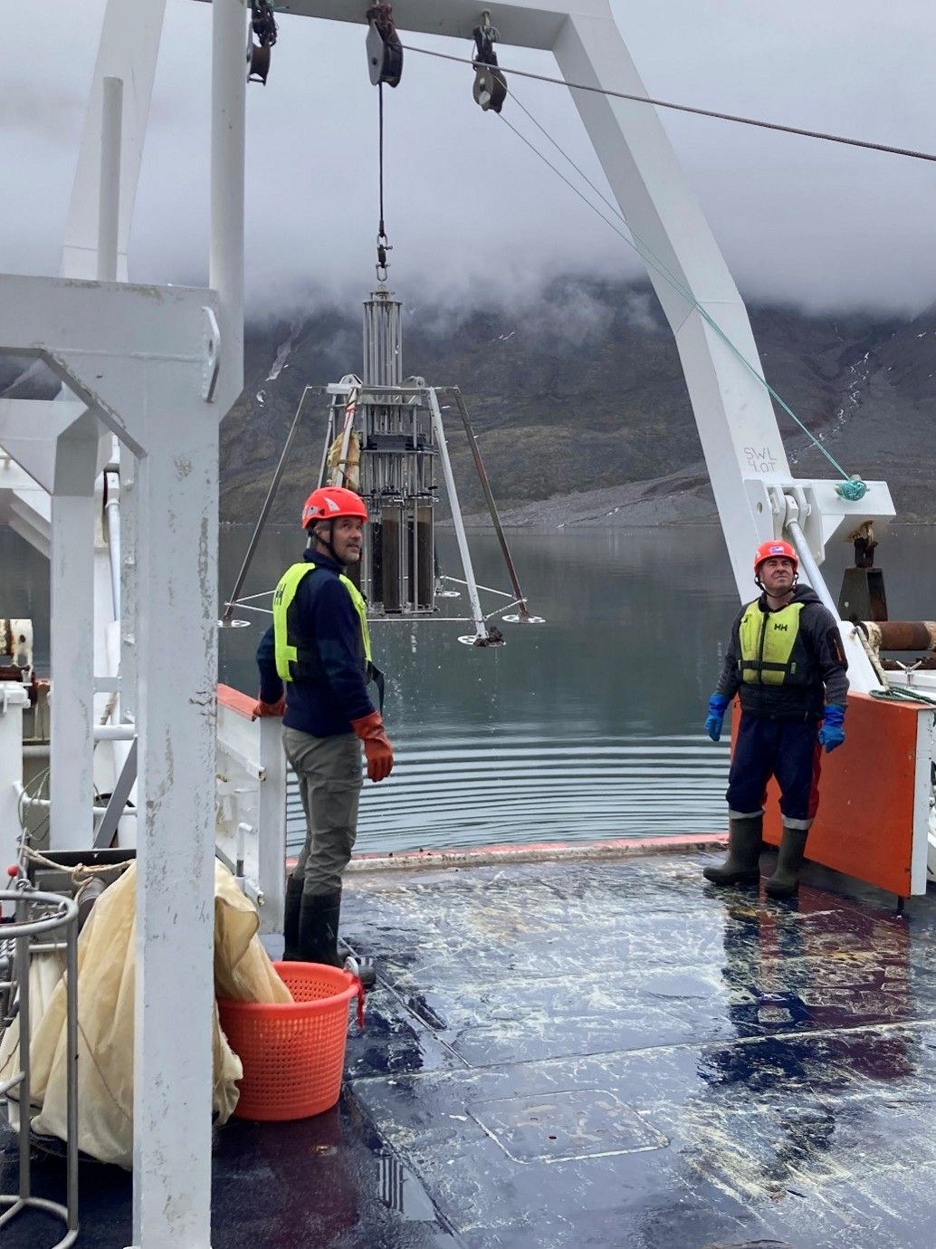 The multicorer bringing sediment cores to the ship in Disko Fjord. Chief scientist and collaborator Mikael Sejr.jpg