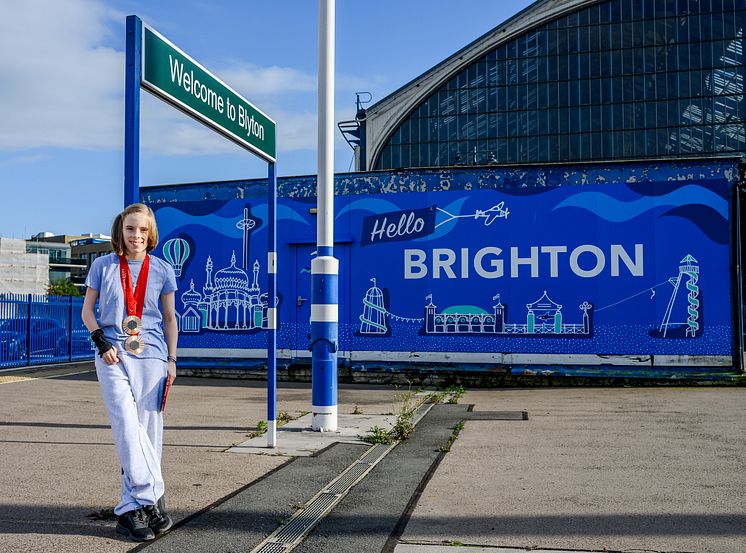 Bly Twomey poses by the new 'Welcome to Blyton' sign in Brighton 