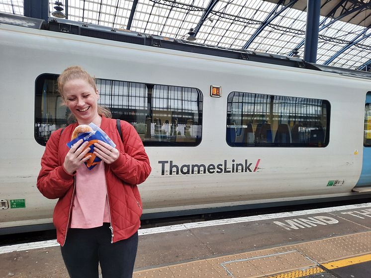 A customer  at Brighton station enjoying an Auntie Anne's pretzel 