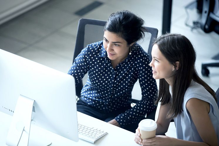 advisory and consulting two women looking at screen.png