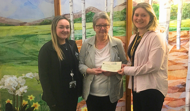 ng home Chairperson Catherine Rossine presents Marie Curie donation 