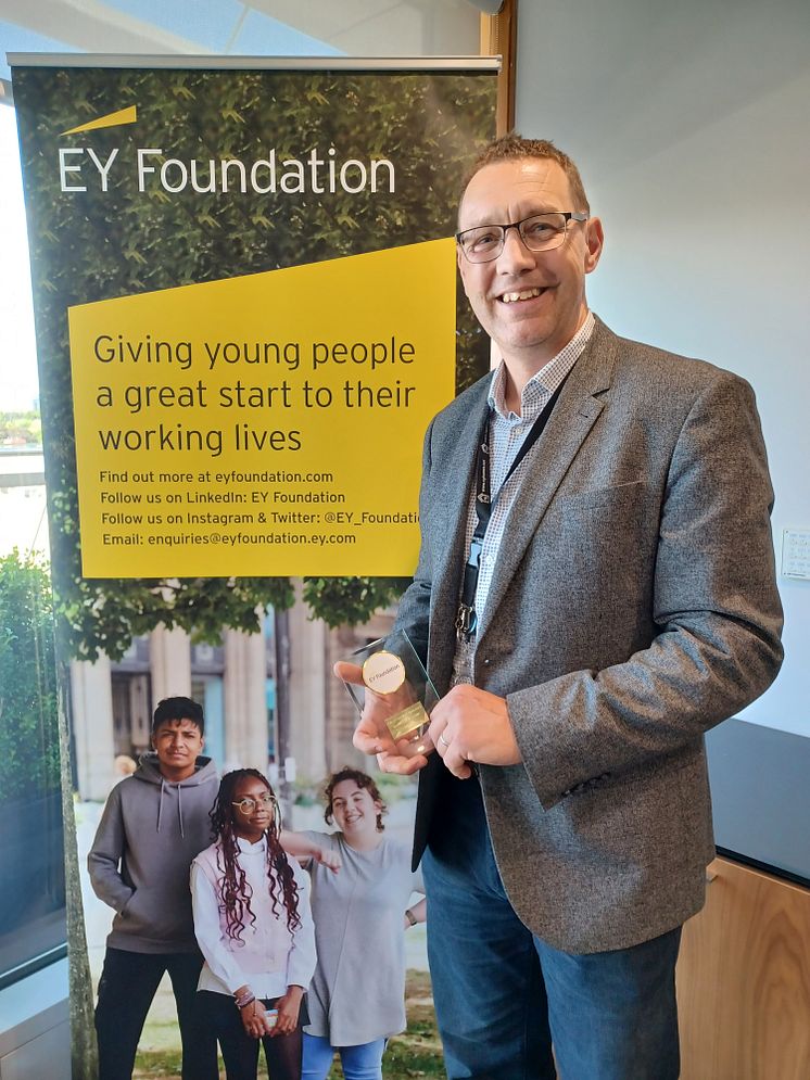 ng homes Project Manager Greg Cann displays his EY Foundation External Volunteer award.jpg