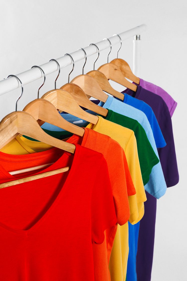 Colorful clothes on hangers against white background - original (1464260).jpeg
