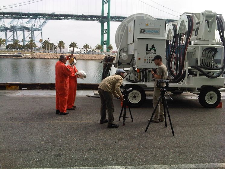 Mårten and Oskar discuss filming tactics beside a Cavotec AMP Mobile unit at the Port of LA #Cavotecfilm #shorepower