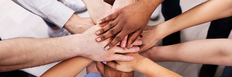 53384144-diverse-people-stacking-hand-together-2