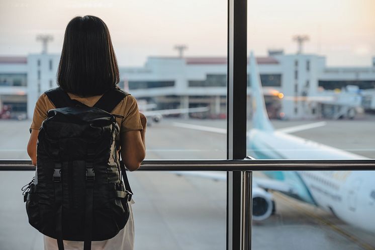 THEME_TRAVEL_AIRPORT_AIRPLANE_WOMAN_TOURIST_STANDING_WITH_LUGGAGE_GettyImages-1312931220_Universal_Within usage period_99798