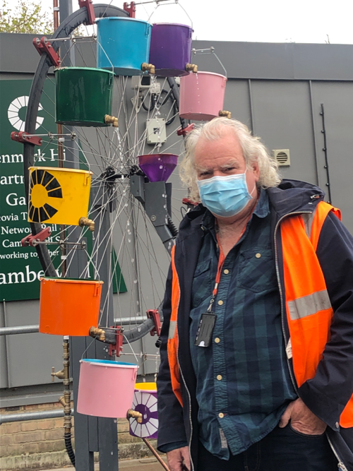 Tony Coleman with his "chaos water wheel" at Denmark Hill station