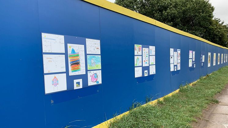 Designs from the pupils at Christ the King Catholic Primary School on the hoarding to the development BoKlok on the Brook in Bristol.