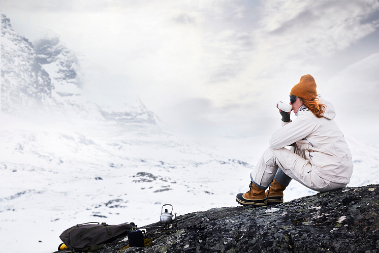 Woman in mountains drinking tea