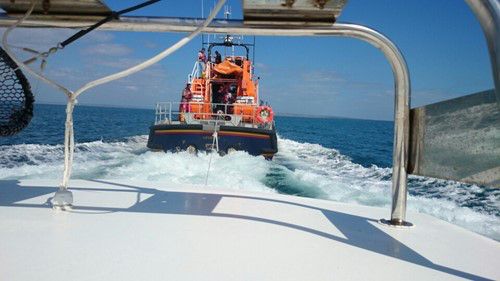 Hi-res image - ACR Electronics - Fisherman Simon Jones is towed to safety