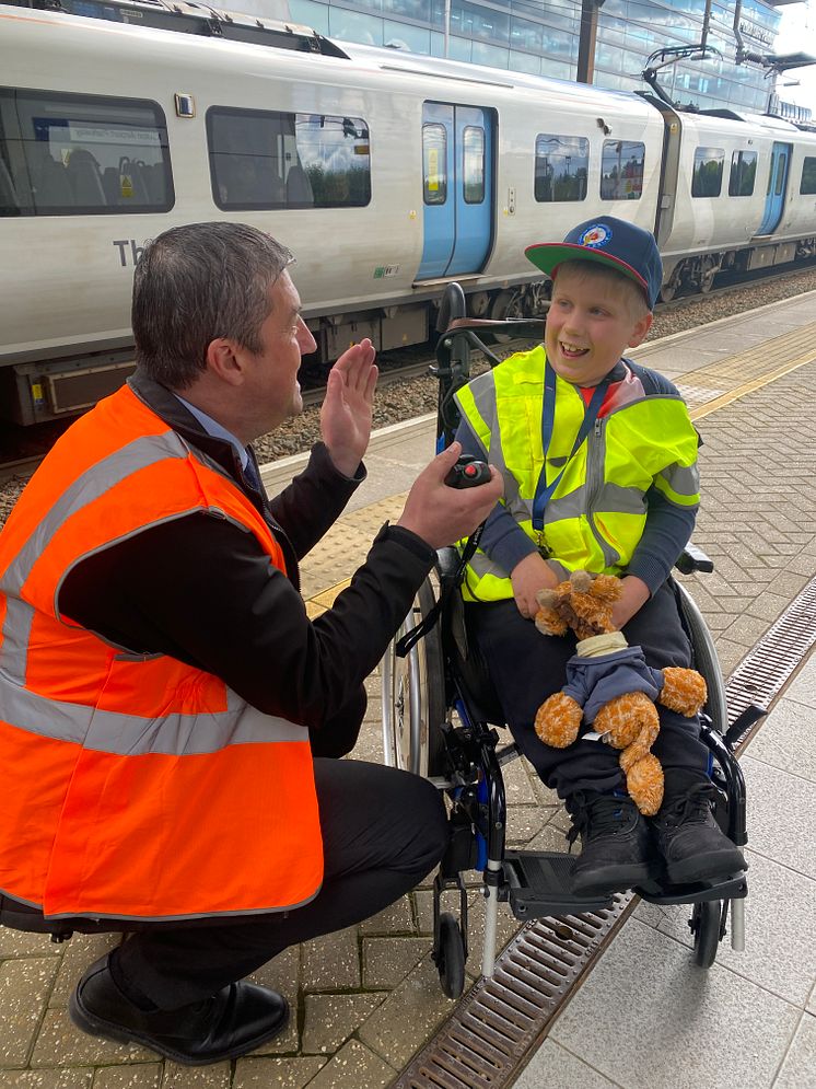 Station manager Joe Healy helps Alfie make announcement at Luton Airport Parkway station.jpeg