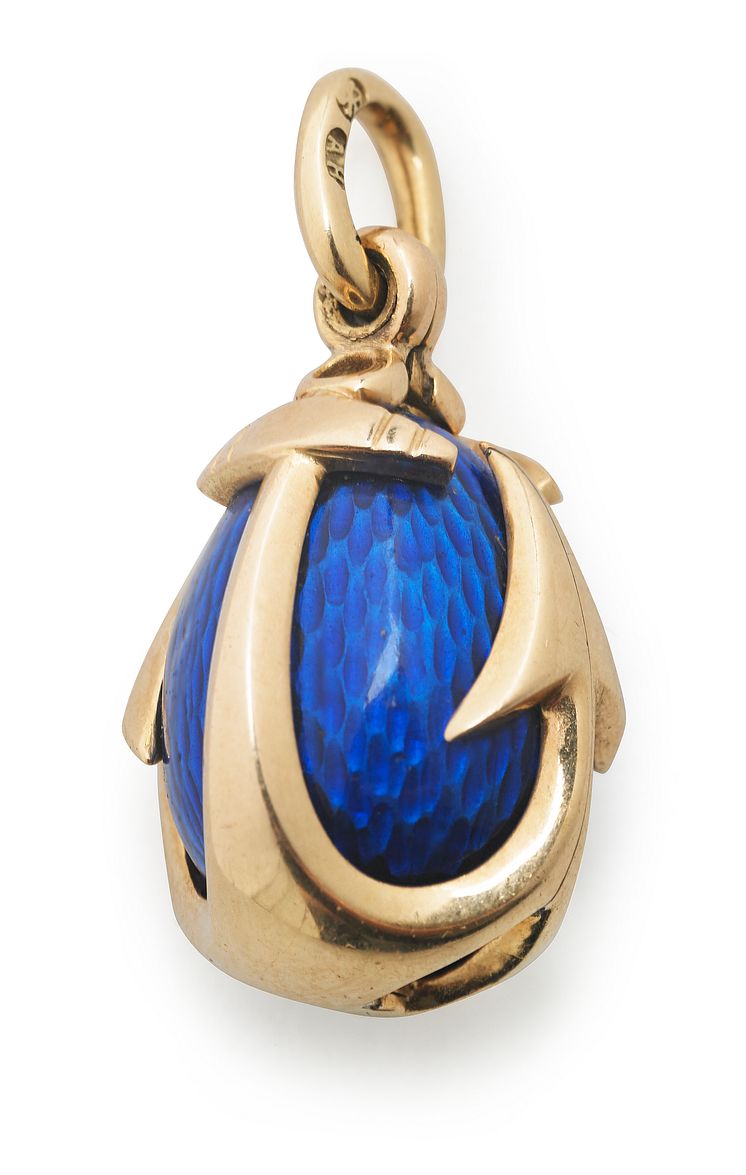 August Holmström: A Russian Easter egg pendant with blue translucent enamel on guilloched ground, set with anchor formed 14k gold cagework.