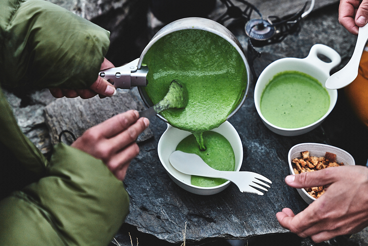 Serving creamy green pea soup