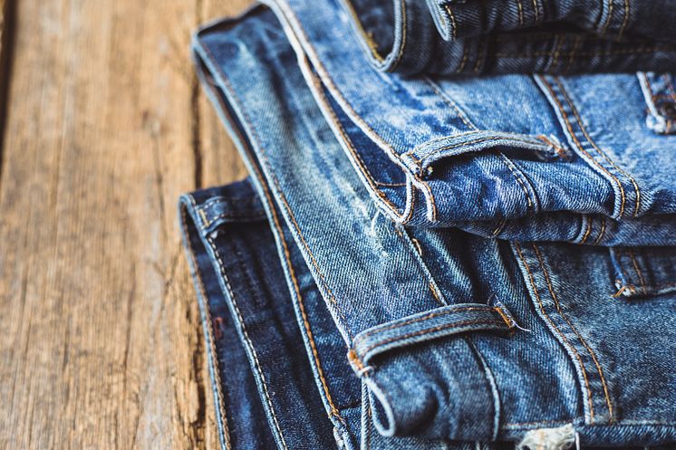 Jeans stacked on a wooden background - original (1464265).jpg