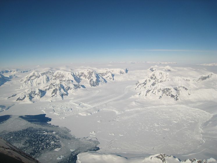 Ice on the Antarctic peninsula flowing along a channel into an ice shelf in the ocean. Hilmar Gudmundsson