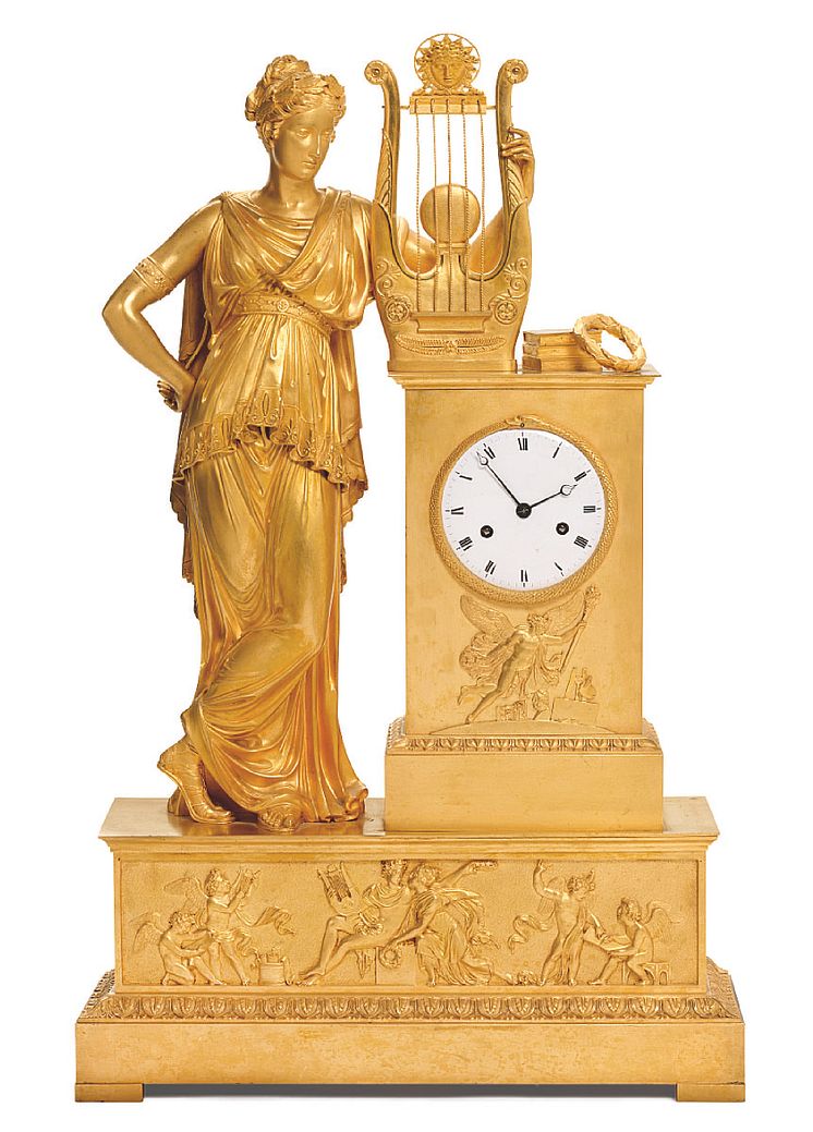 A large French Empire gilt bronze mantel clock