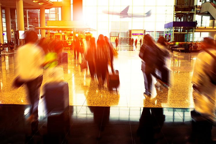 32726063-people-with-traveling-luggage-walking-in-airport-terminal