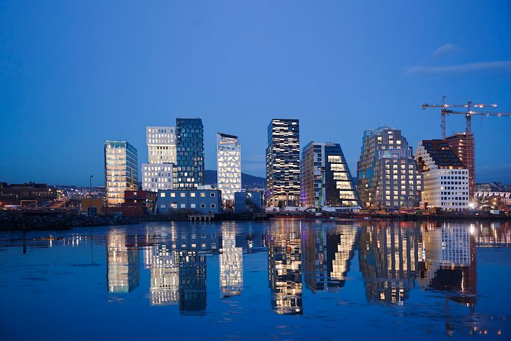 Skyline of Oslo at night reflecting in water