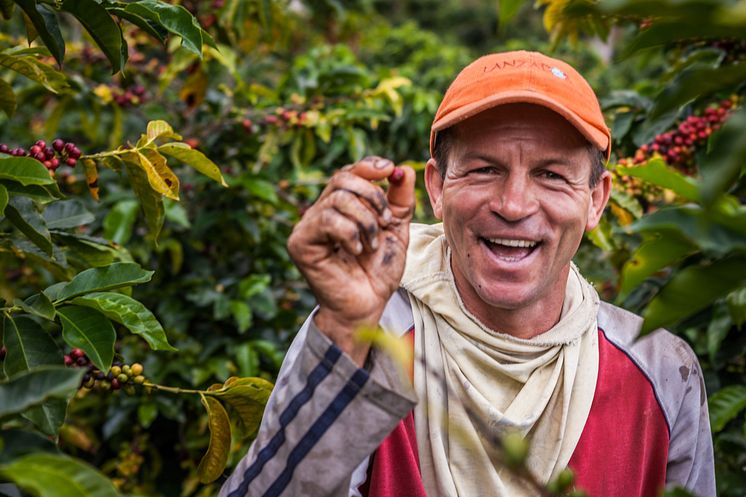 colombian-farmer-showing-a-coffee-cherry_52371621778_o