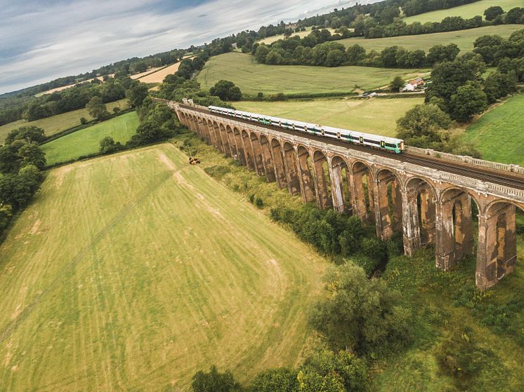 A Southern train cruises over the Ouse Valley Viaduct