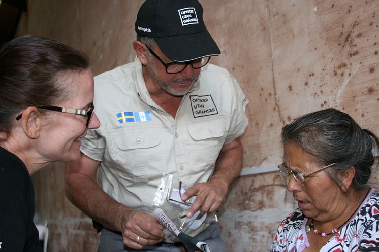 John Godoy som hjälper en kvinna med glasögon - Optiker utan gränser 2015