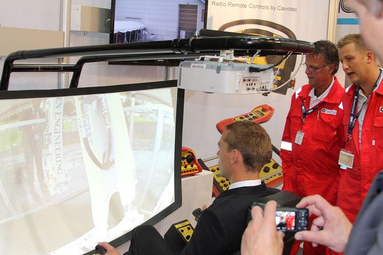 Norway's Minister of Petroleum and Energy, Ola Borten Moe, operates an excavator using a Cavotec radio remote control video link system at ONS 2012