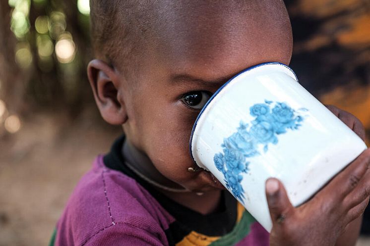  Abdi drinks a cup of milk ,five months after recovering from SAM, at their home, Ethiopia