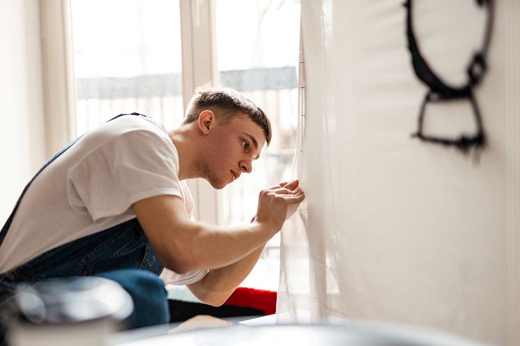 53540955-young-man-wearing-overall-working-on-craft-rug2